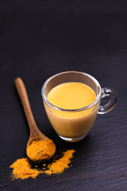Indian turmeric milk with saffron, cardamom and turmeric. Copyspace