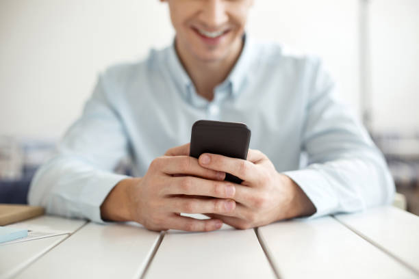 istock Smiling man typing on a modern phone 922542724