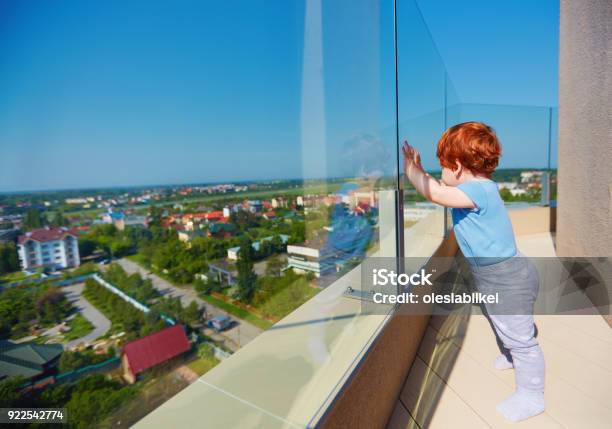 Infant Baby Boy Enjoying The City View From The Rooftop Patio At Multi Storey Building Stock Photo - Download Image Now