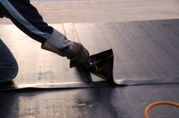 laying of waterproofing sheathing  and insulation on a roof stock photo