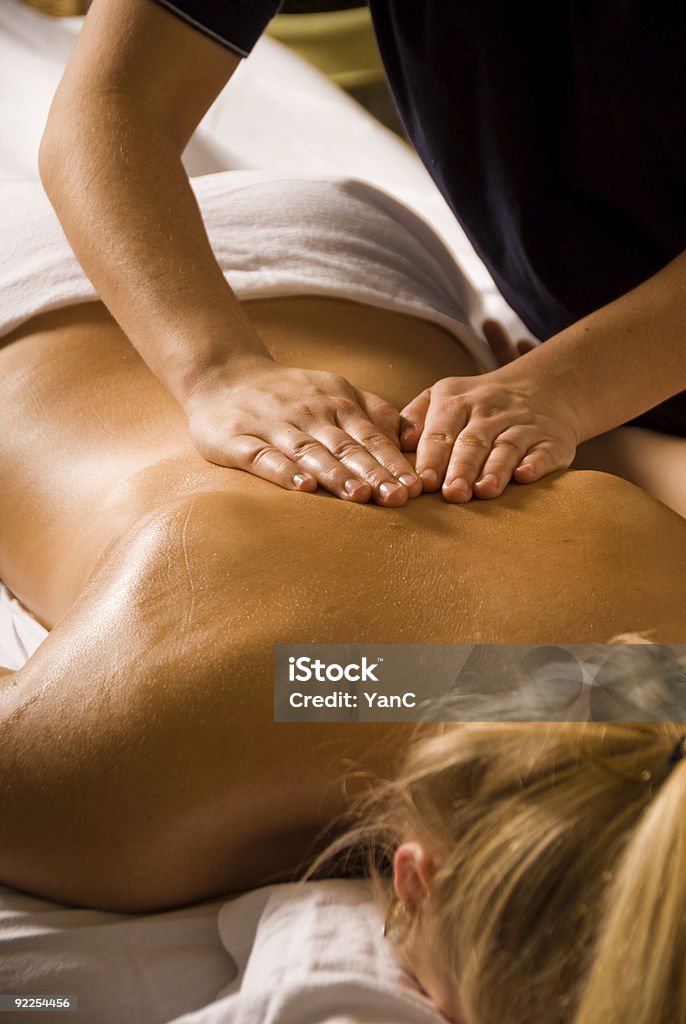 Close-up of a Swedish massage technique called effleurage woman at a day spa getting a relaxation massage Massaging Stock Photo