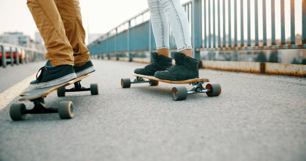 istock Young attractive couple riding skateboards and having fun 922546376