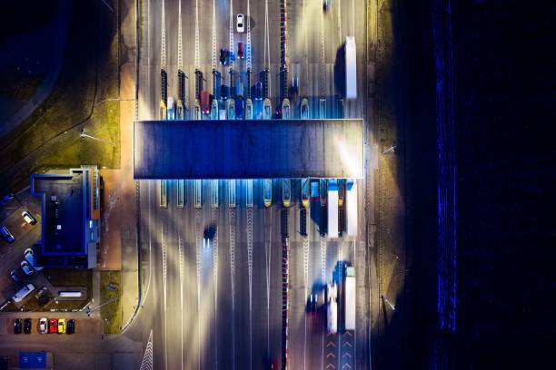 istock Aerial drone view on toll collection point on motorway at night. 922546898
