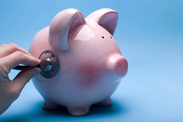 A combination lock protects the savings inside a piggy bank stock photo