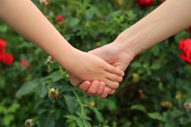 istock Mother and daughter hands together 922547086