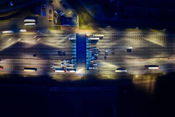 istock Aerial drone view on toll collection point on motorway at night. 922547418