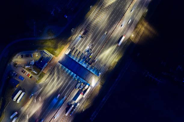 istock Aerial drone view on toll collection point on motorway at night. 922547550