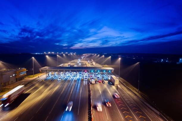 istock Aerial drone view on toll collection point on motorway at night. 922547886