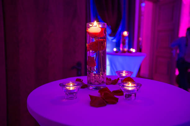 istock Glass vase with red roses water and light candles 922551480