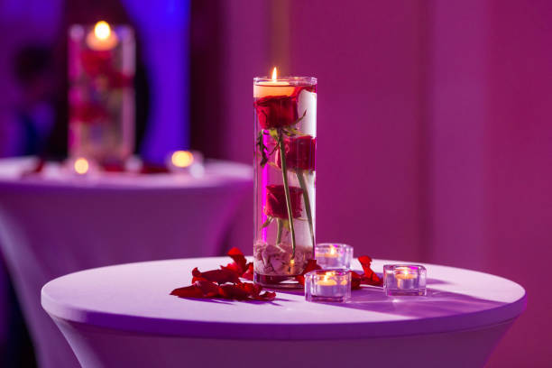 istock Glass vase with red roses water and light candles 922551534