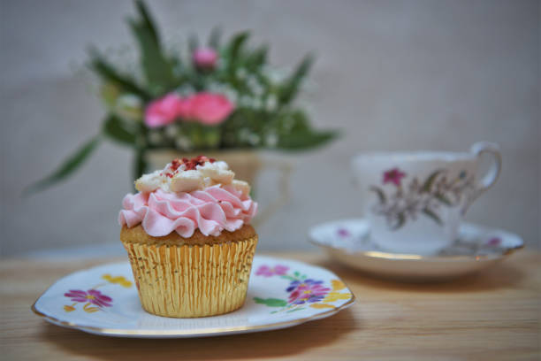 istock vintage afternoon tea with cupcake and fresh flowers 922551742