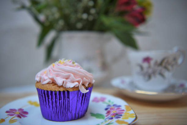 istock vintage afternoon tea with cupcake and fresh flowers 922551892