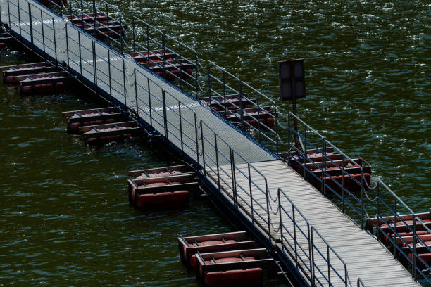 close-up of the descent to the pontoon of the Hendaye marina. Solitaire wood and aluminum railings. Completely calm sea.