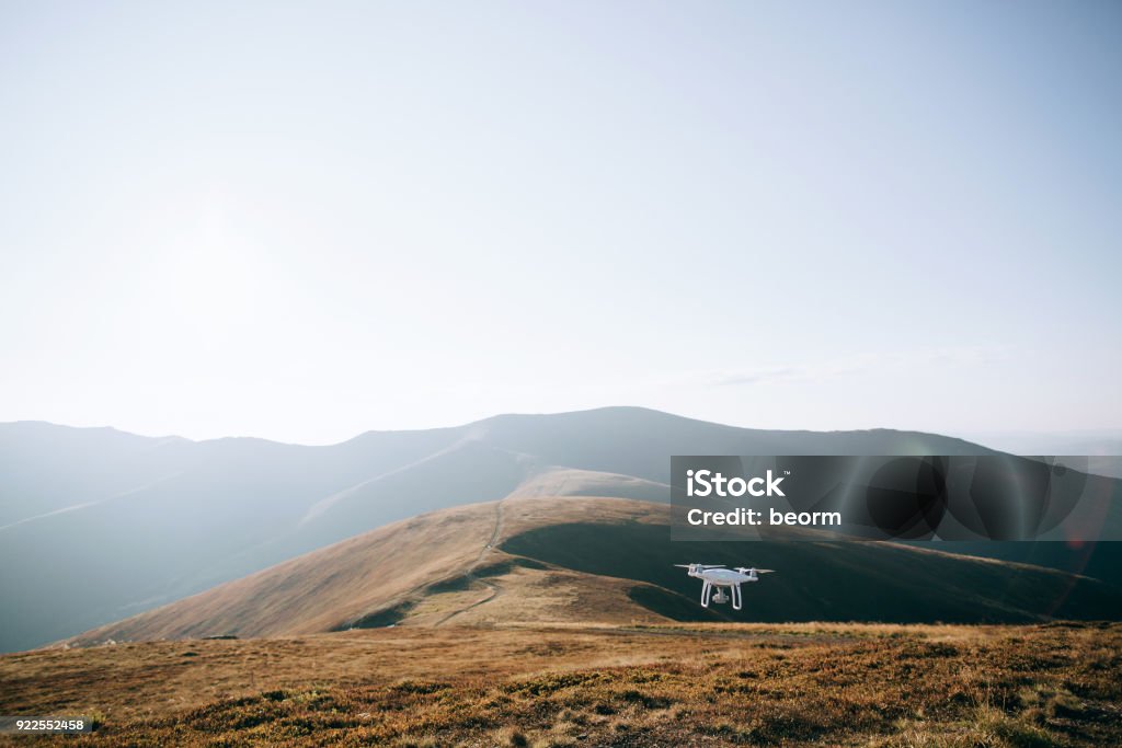 drone copter flying with digital camera in mountains Drone Stock Photo
