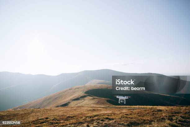 Drone Copter Flying With Digital Camera In Mountains Stock Photo - Download Image Now