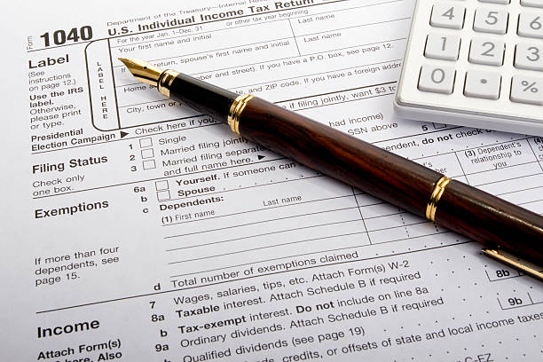 US 1040 Tax Form with Calculator and fountain pen stock photo