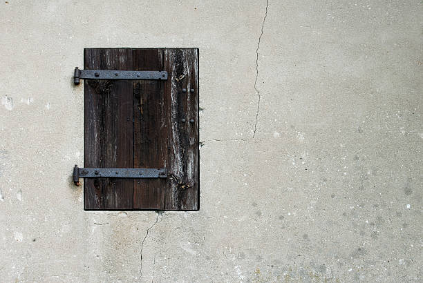 stony wall with wooden window stock photo