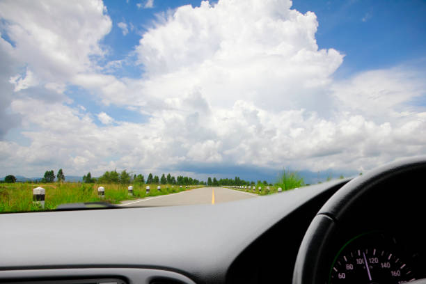 istock Road trip through the mountains. View from the car.Empty country road with cloudy sky 922559010