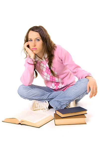istock bored student sitting on the floor with books 92256044