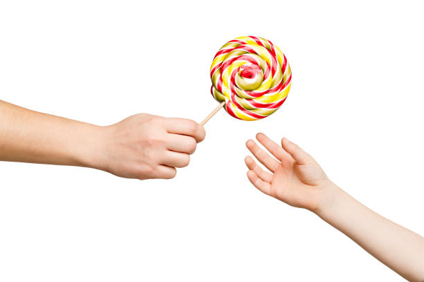 woman giving lollipop to kid, isolated - lollipop isolated multi colored candy imagens e fotografias de stock