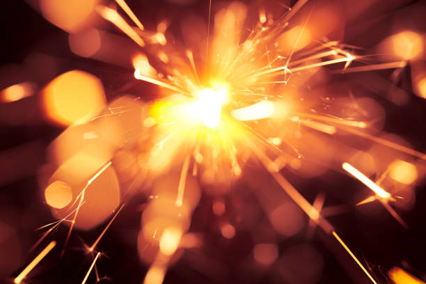 istock Abstract Centered Yellow Sparks - Sparkler Background Party New Year Celebration Technology 922561420
