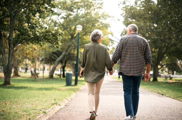 Forever is the best kind of together Rearview shot of a senior couple going for a walk in the park couple holding hands stock pictures, royalty-free photos & images