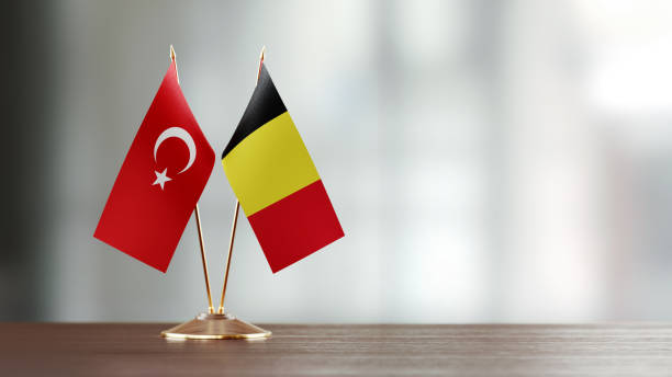 istock Turkish And Belgian Flag Pair On A Desk Over Defocused Background 922562184