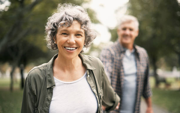 I’ll go anywhere as long as we’re together Portrait of a happy senior couple going for a walk in the park spirit guides stock pictures, royalty-free photos & images