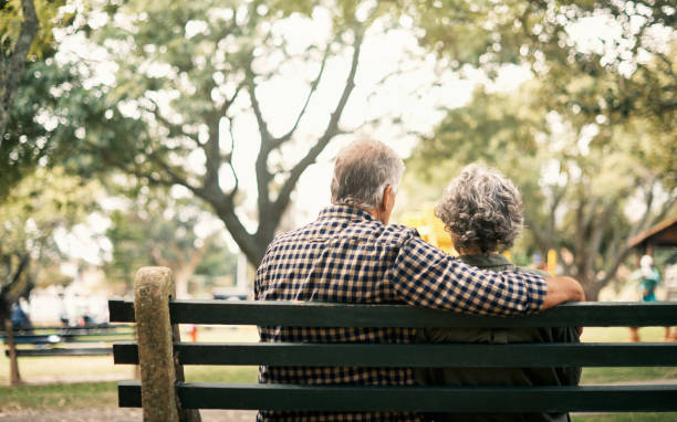 Old love is the truest love Rearview shot of a senior couple relaxing on a park bench bench stock pictures, royalty-free photos & images