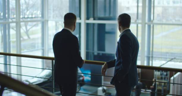 istock Two men having conversation in car showroom 922562552
