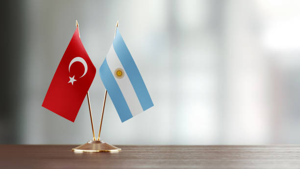 istock Turkish And Argentinian Flag Pair On A Desk Over Defocused Background 922562602