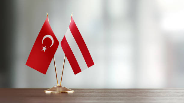 istock Turkish And Austrian Flag Pair On A Desk Over Defocused Background 922562728