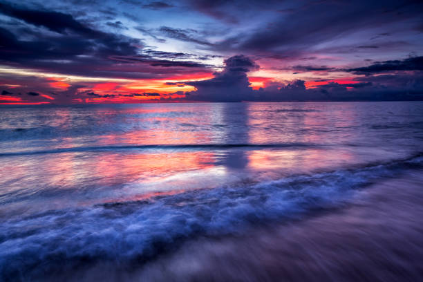 istock Soft wave of blue ocean on sandy beach at sunset. Background. 922564966