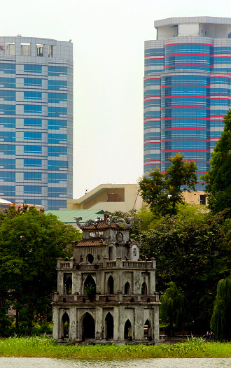 Ngoc Son Temple on Hoan Kiem Lake in Hanoi with two new high rise buildings in the background