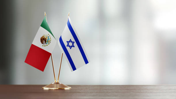 istock Mexican And Israeli Flag Pair On A Desk Over Defocused Background 922565346
