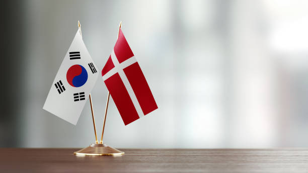 istock South Korean And Danish Flag Pair On A Desk Over Defocused Background 922565818
