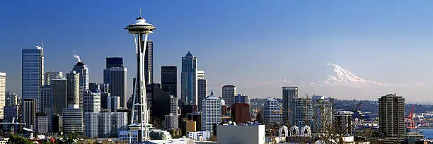 Panoramic shot of the Seattle, Washington skyline from Queen Anne neighborhood looking south toward Mount Rainier and the Seattle Space Needle on a beautiful sunny day. 