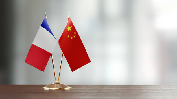 istock French And Chinese Flag Pair On A Desk Over Defocused Background 922569390
