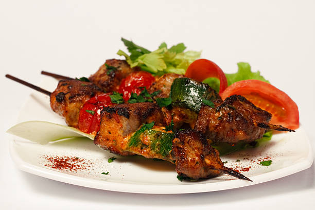 istock Grilled meat on wood sticks - shashlyk (close-up) 92257331