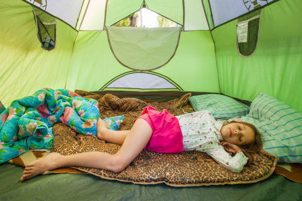 istock Young cute girl sleeping in a tent in summer 922574414