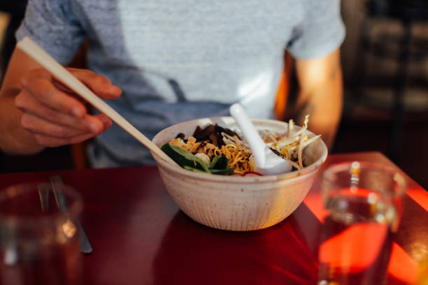 istock Man enjoys plate of spicy hot pho 922574466