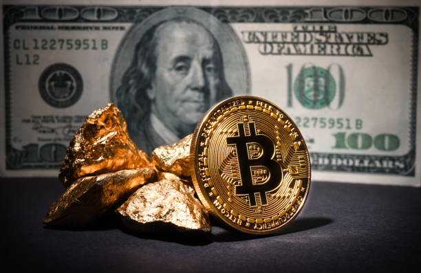 Bitcoin and gold nuggets on dollars stock photo