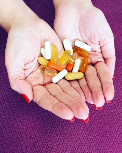 Pills and Vitamins in woman hands