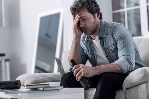 istock Unshaved man feeling terrible after consuming a lot of alcohol 922578520