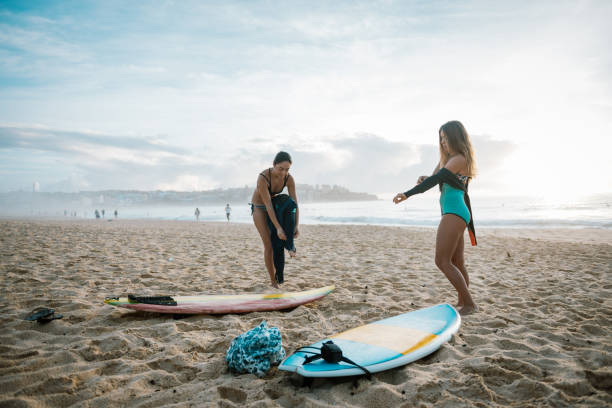 istock Two surfers putting on wet suits for surfing 922580380