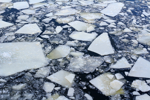 Broken ice on the surface of the river in winter