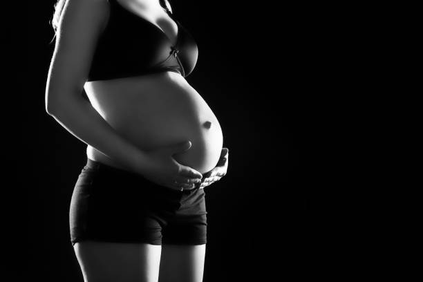 istock Pregnant woman touching her belly. 922586462