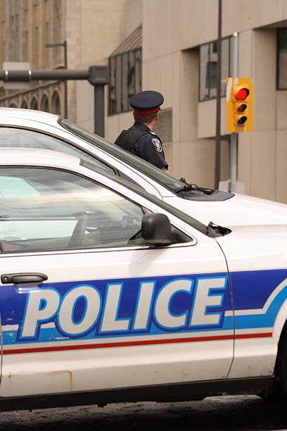 istock Policeman by Police Cars 92258796