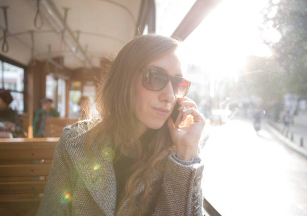 istock Young woman using smart phone on the tram 922591198