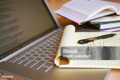 istock Laptop computer with books, pen and yellow legal pad 92259124